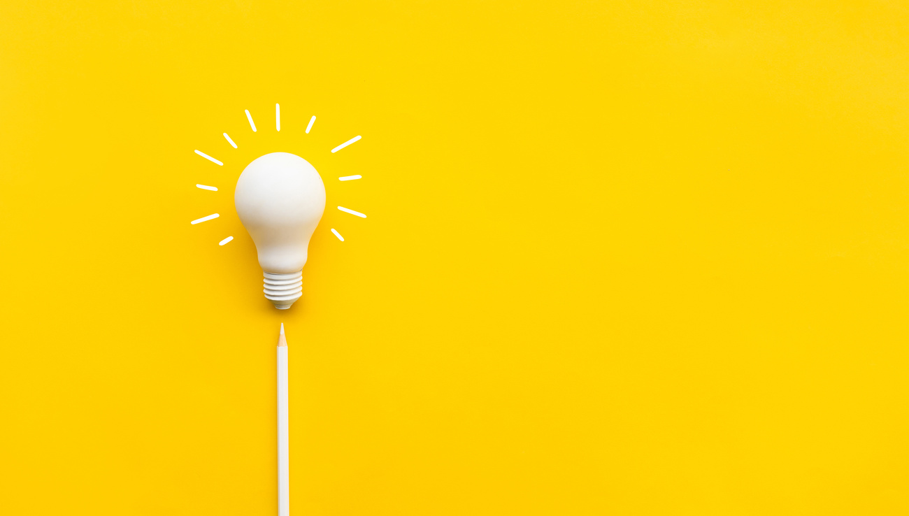 Business creativity and inspiration concepts with lightbulb and pencil on yellow background